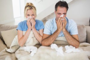 Couple suffering from cold in bed